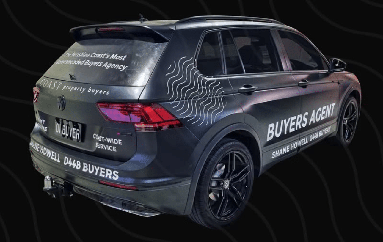Coast Property Buyers vehicle featuring a full matte black vinyl car wrap